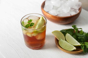 Glass with Cuba Libre cocktail on table