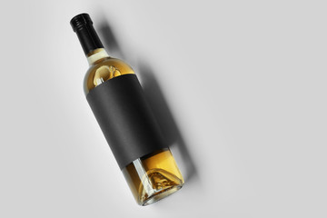 Bottle of wine with blank label on light background. Mock up for design © Africa Studio