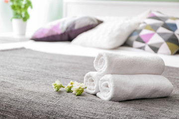 Clean soft towels on bed