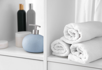 Clean soft towels on shelf