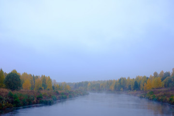 Naklejka na ściany i meble Foggy landscape in autumn.