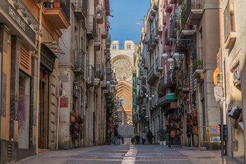 Cathedral of Tarragona at the end in the street in the middle of the trade of the old quarter of the Catalan city in Spain - obrazy, fototapety, plakaty