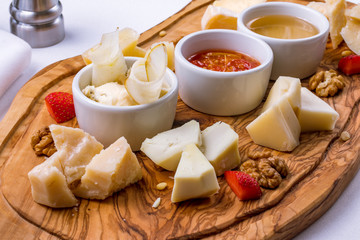 Assorted cheeses on wooden Board