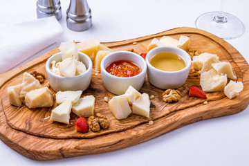 Assorted cheeses on wooden Board