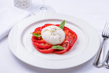 Tomatoes with burrata cheese and basil