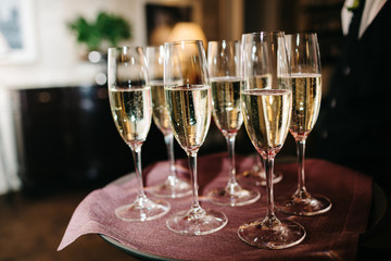 waiter brings glasses of champagne