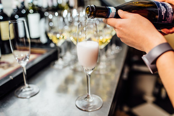 waiter brings glasses of champagne