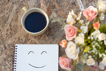 Happy weekend concept. Cup of coffee on wooden floor with .pink flower in pot  vintage color tone.