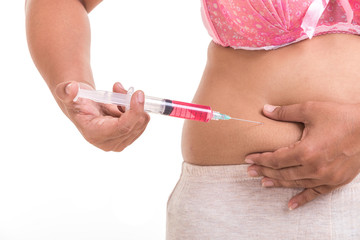 Fat woman holding syringe and inject red medicine to her belly isolated on white