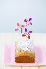 Sugar dusted pound cake with festive pinwheel toppers. 