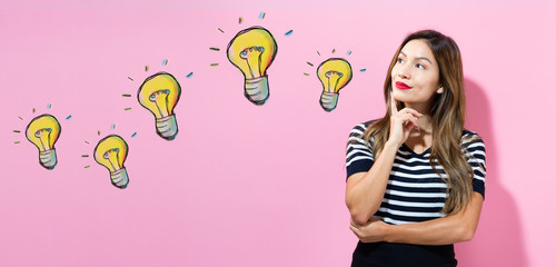 Light Bulbs with young woman in a thoughtful pose