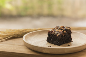 Chocolate brownie dessert on wooden background close up
