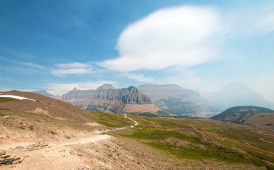 Hidden Lake hiking trail under lenticular cloud on Logan Pass in Glacier National Park during the 2017 fall fires in Montana United States