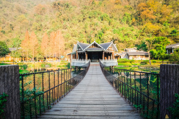 Fototapeta na wymiar Traditional chinese old house and wooden bridge