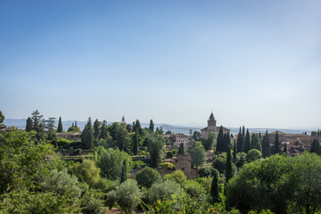 Fototapeta na wymiar View of the bell tower of the Alhambra and tha palace from the Generalife gardens in Granada, Spain, Europe