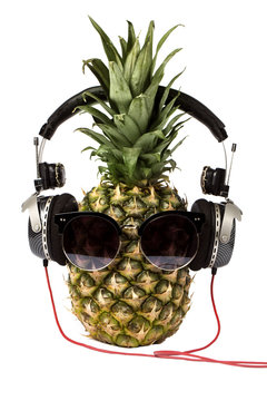 pineapple in headphones and sunglasses isolated on white background