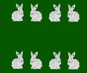 White bunnies on green background