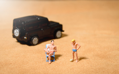 miniature people father and son playing on the beach.family summer beach vacation concept