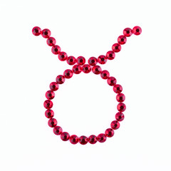 Taurus. Sign of the zodiac of red rhinestones on a white background.