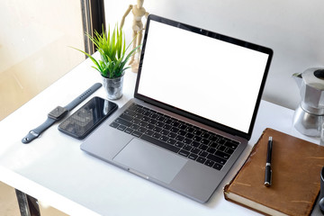 Stylish workspace with mockup blank screen laptop, books, smartphone on table