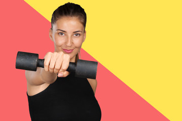 young woman doing a fitness workout with dumbbells