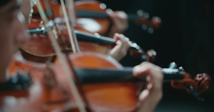 symphony orchestra performance, stringed instruments detail shot