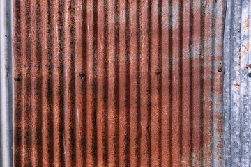 old rusty galvanized. wheathered rust and scratched steel texture corrugated iron siding vintage background.