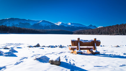 Bench close to the frozen lake in Canada