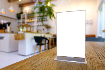 Mock up Menu frame standing on wood table in Bar restaurant cafe. space for text