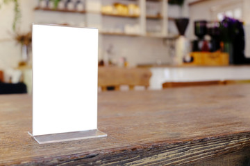 Mock up Menu frame standing on wood table in Bar restaurant cafe. space for text