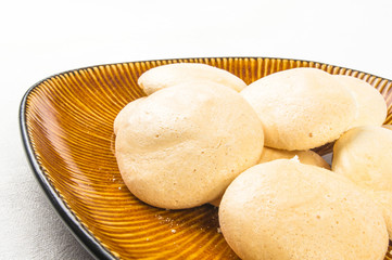brown plate with meringues