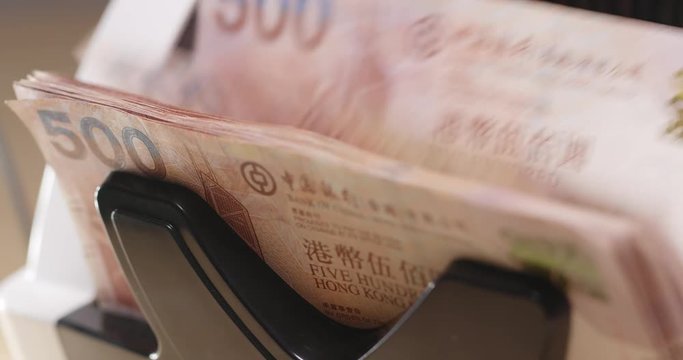 Money counting machine counting Hong Kong dollar close up