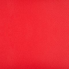 A piece of bright red artificial leather texture closeup