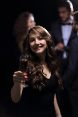 beautiful young woman raising his glass in a casino