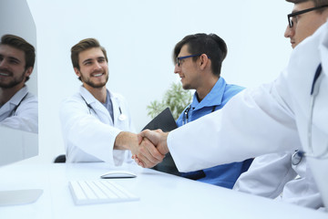 handshake between the two doctors during the working meeting