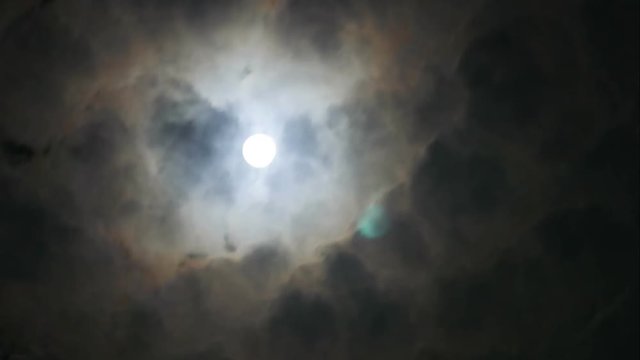 time-lapse of running rainy dark cloud in the sky with moon