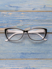 optical glasses on a wooden background. 