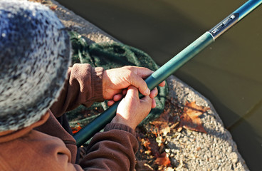 Hands holding fishing rod