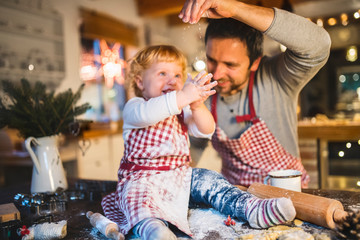 Young family making cookies at home.