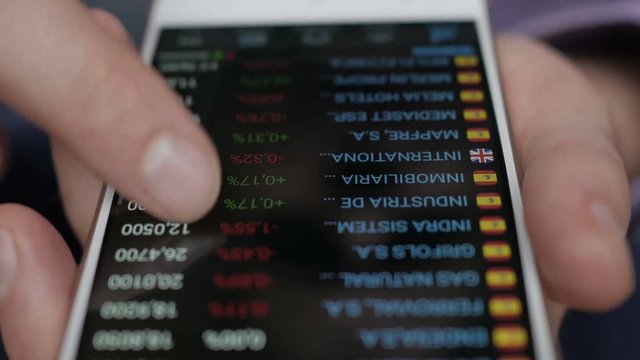 Businessman reading financial news. Stock market, trading online, trader working with smartphone on stockmarket trading floor. Man touching screen, browse foreign exchange market data, chart. Forex.
