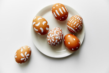 Eggs painted various white patterns on Easter holiday. White background, copy space, minimalistic concept