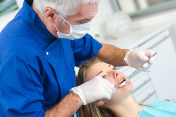 dentist curing a female patient