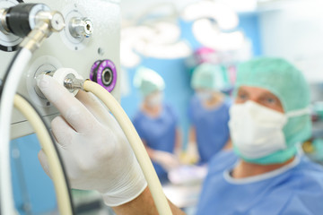 surgery assistant perfusionist operating a modern heart lung machine