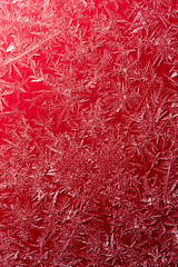 Snowflake on a red fence as a background