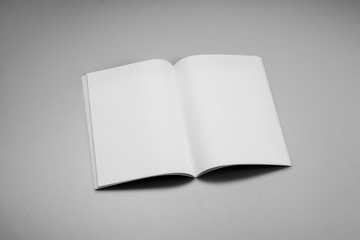 Mock-up magazine, book or catalog on gray table. Blank page or notepad on solid background. Blank...