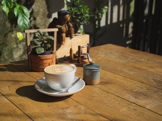 Hot Coffee cup on the wooden table at coffee shop
