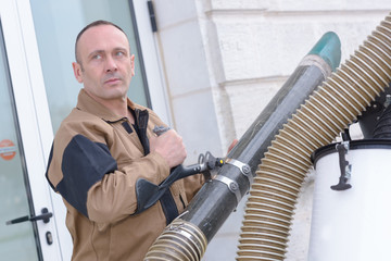 man setting up ventilation system outdoors