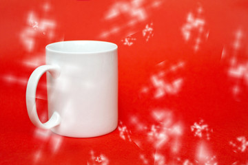 Obraz na płótnie Canvas White mug on red background. Copy space for writing. White glass isolated