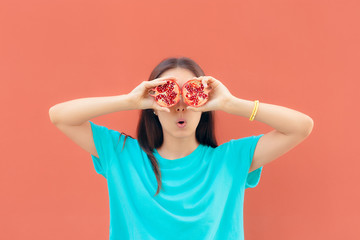 Funny Surprised Woman Holding Pomegranate Halves 