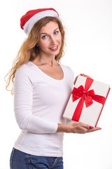 Beautiful caucasian wearing red christmas hat and holding new year gift box. Studio shooting isolated on white
